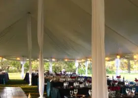 Interior of Pole Tent with aluminum center poles and legs covered by draping